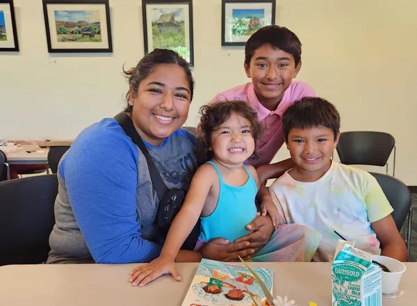 Child smiling at Share Vancouver community event