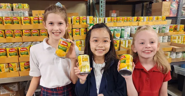 Young girls holding fresh corn from Share Vancouver's food program